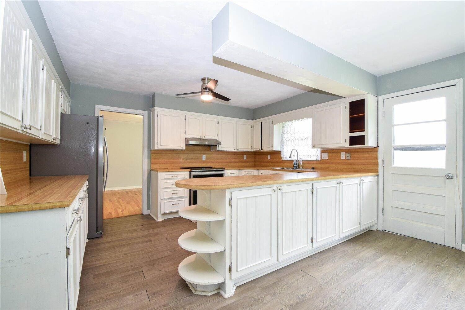 1316 Dudley Road Moneta, VA 24121 - Photo 13 of 37 a kitchen with white cabinets and appliances