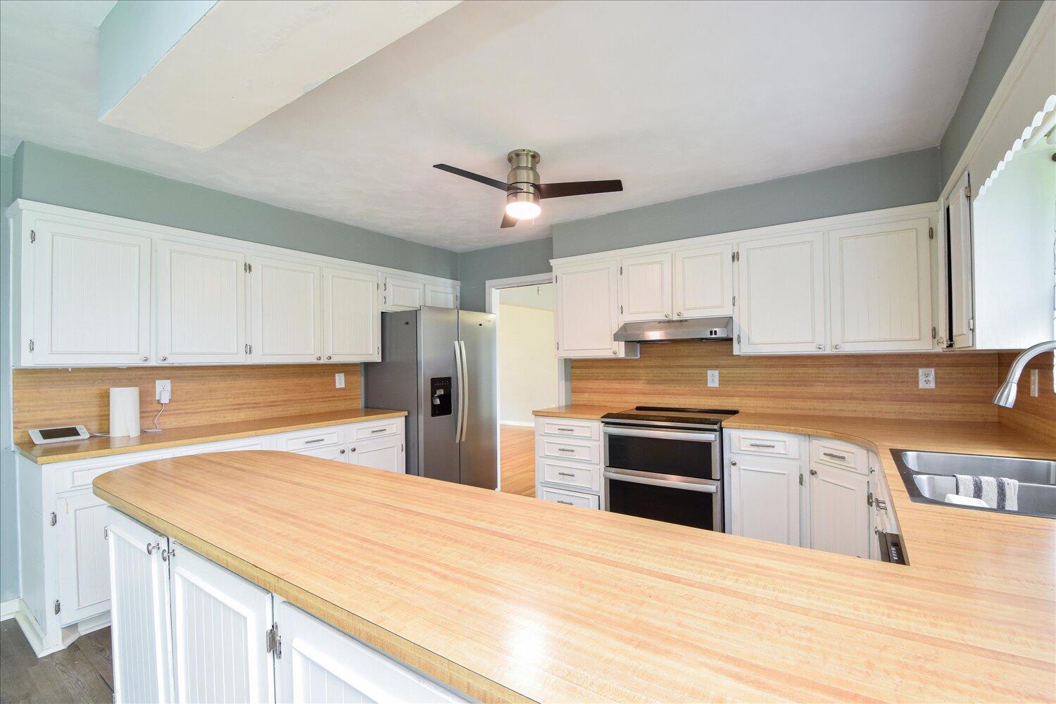 1316 Dudley Road Moneta, VA 24121 - Photo 14 of 37 a kitchen with a stove a sink and a refrigerator