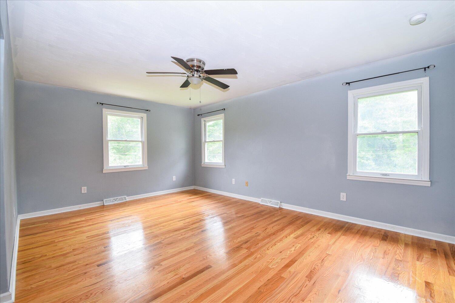 1316 Dudley Road Moneta, VA 24121 - Photo 17 of 37 a view of empty room with wooden floor and fan