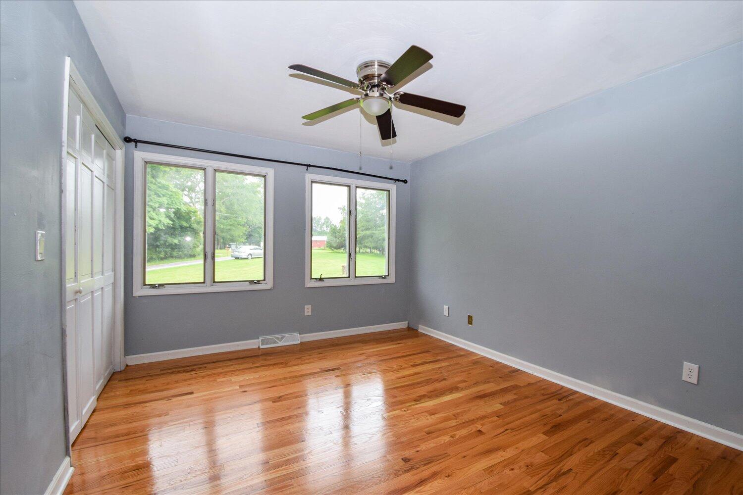 1316 Dudley Road Moneta, VA 24121 - Photo 21 of 37 a view of empty room with wooden floor and fan