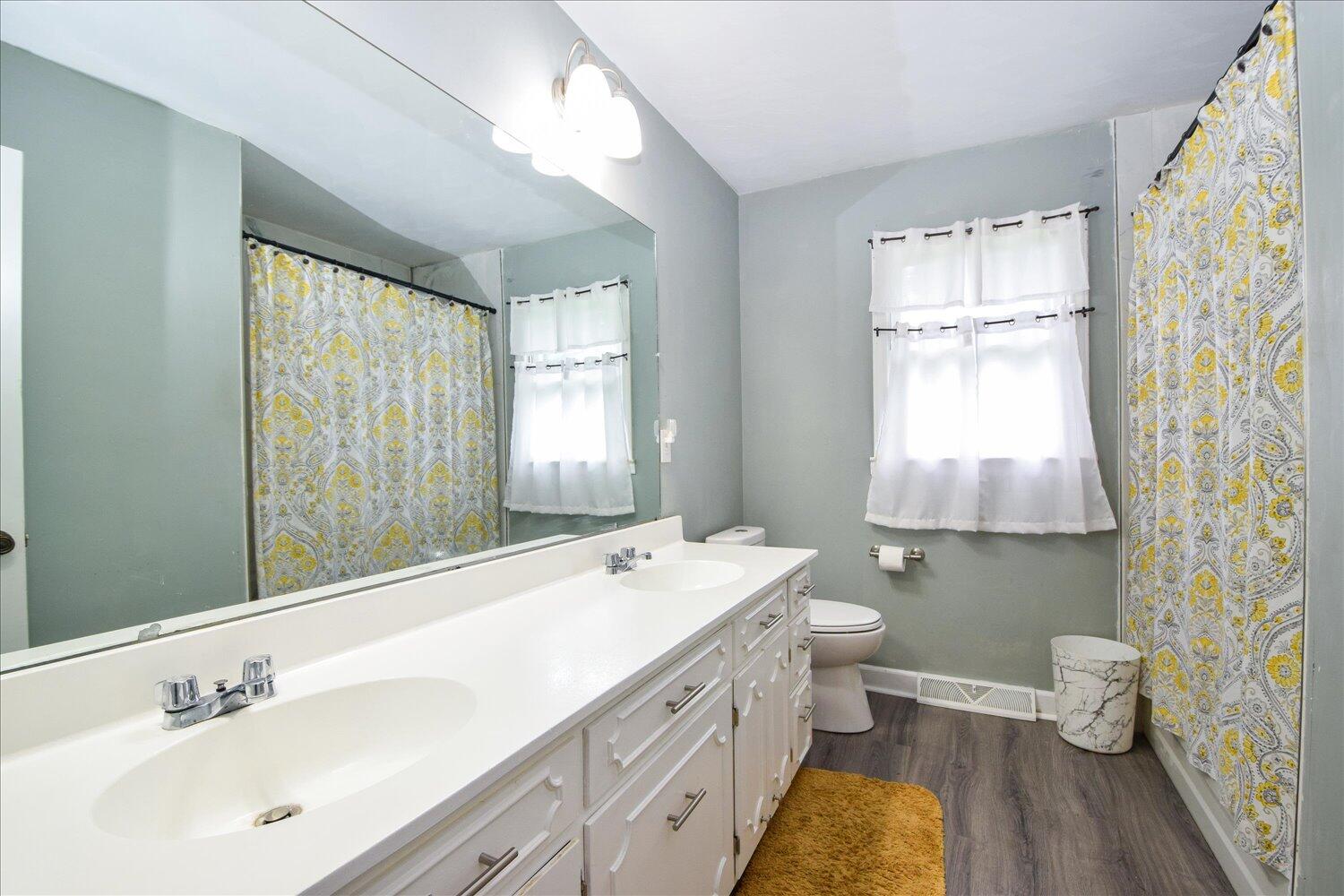 1316 Dudley Road Moneta, VA 24121 - Photo 22 of 37 a spacious bathroom with a double vanity sink toilet and a tub