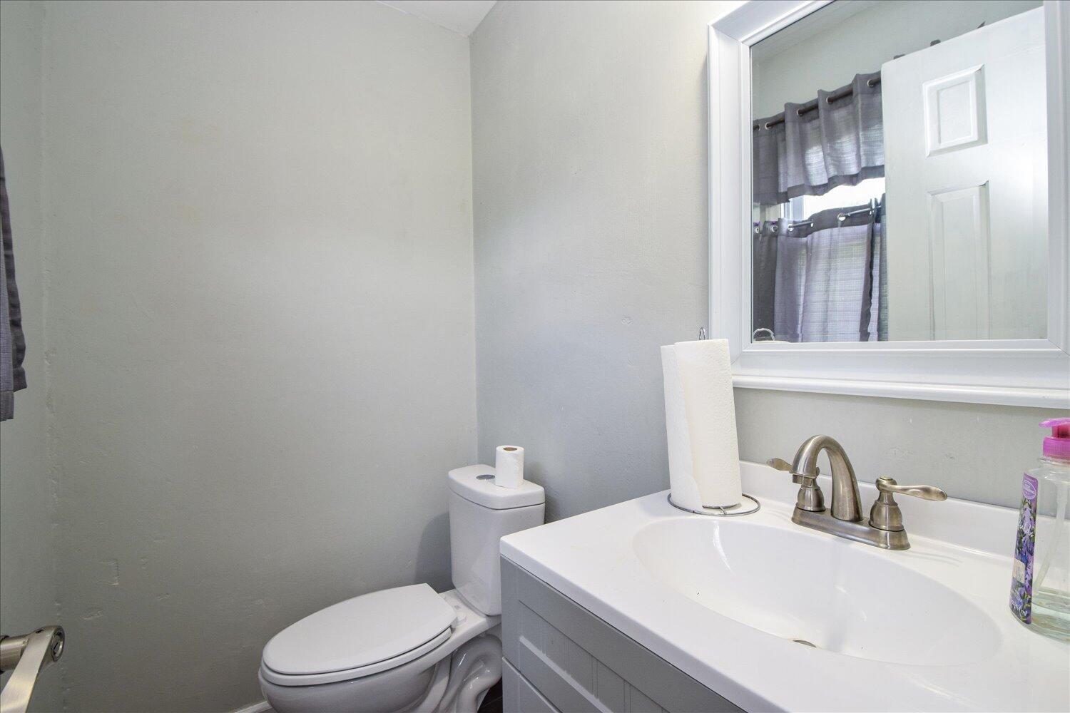 1316 Dudley Road Moneta, VA 24121 - Photo 25 of 37 a bathroom with a sink a toilet and mirror
