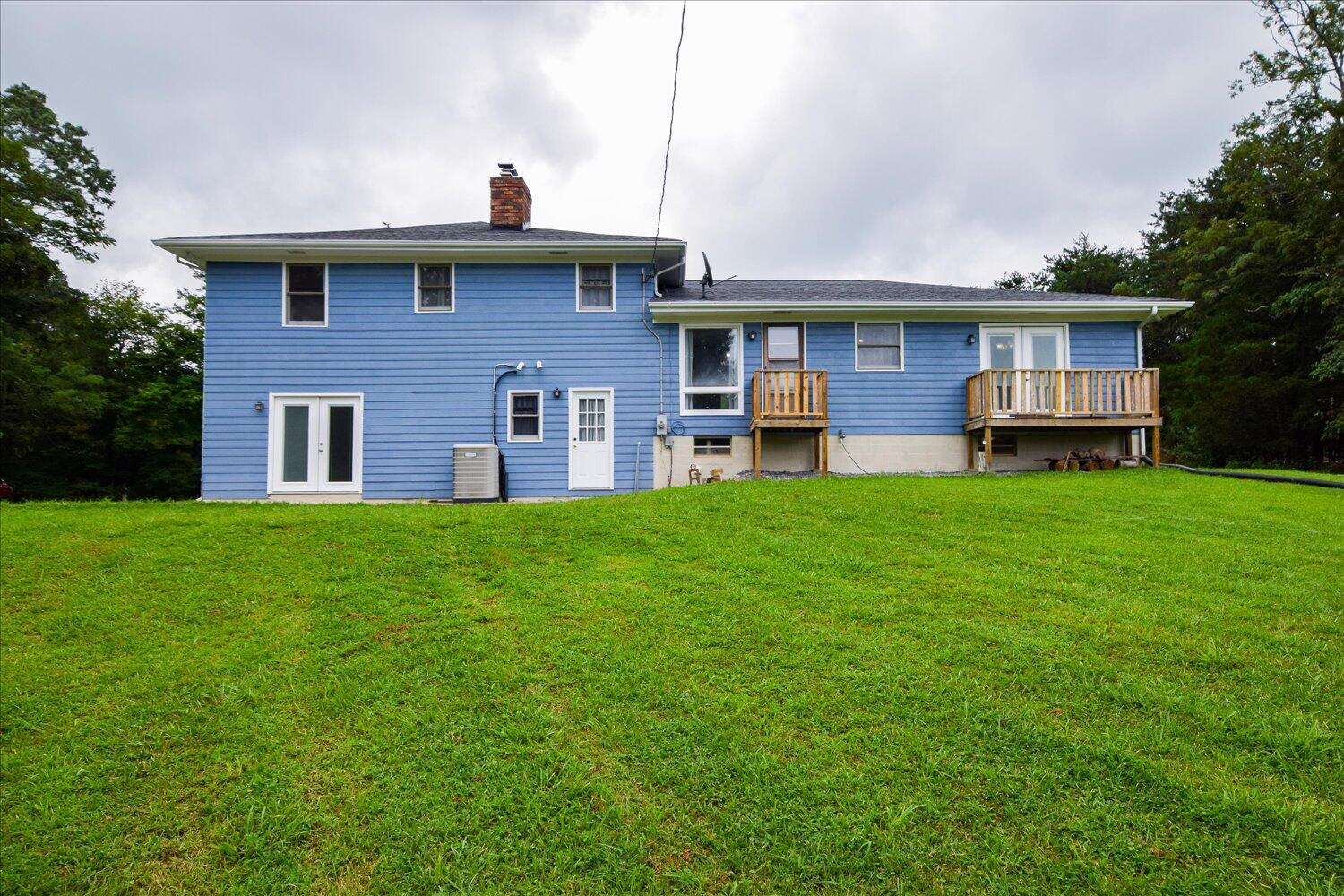 1316 Dudley Road Moneta, VA 24121 - Photo 33 of 37 a brick house with a yard