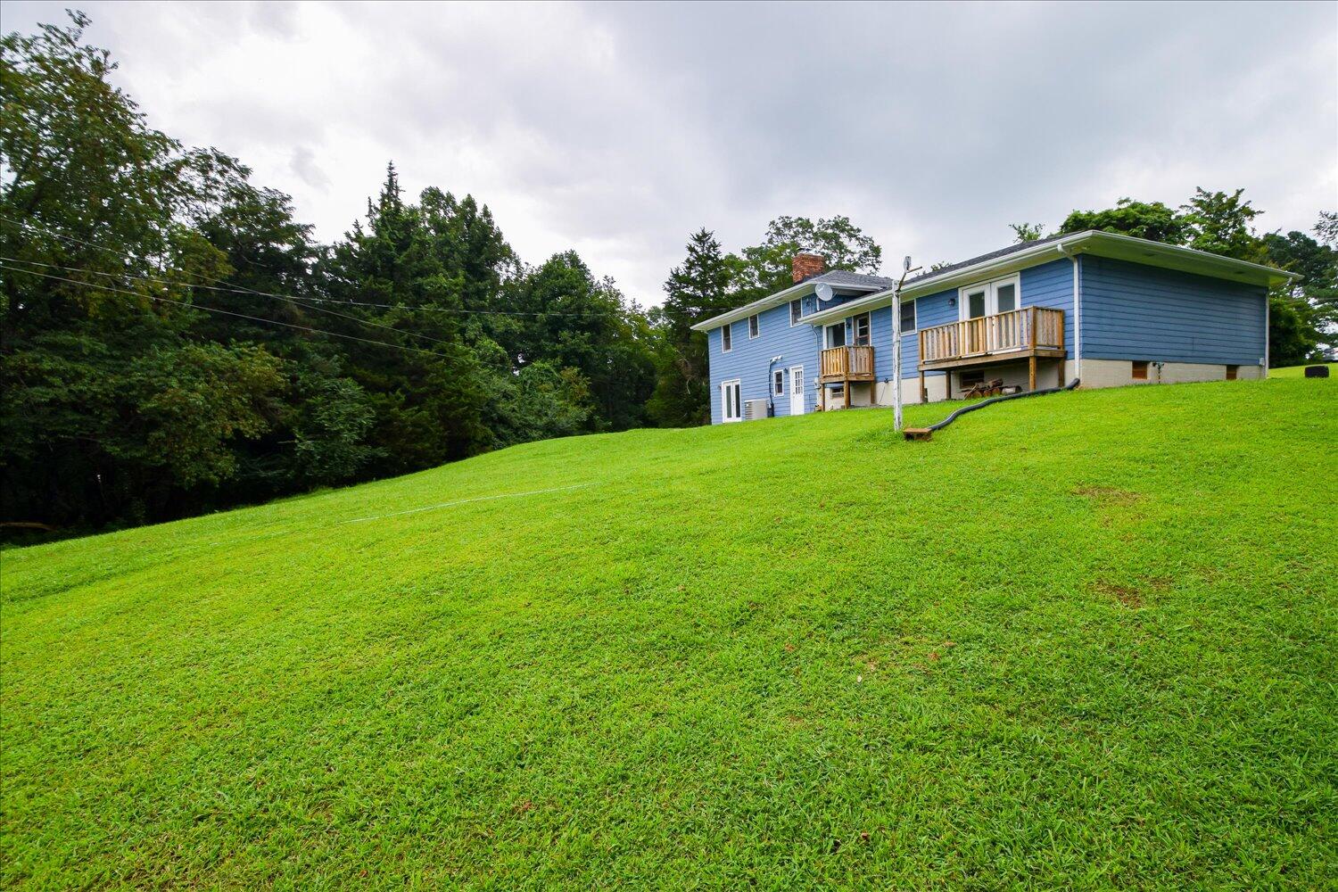 1316 Dudley Road Moneta, VA 24121 - Photo 34 of 37 a yellow and red house sitting in the grass