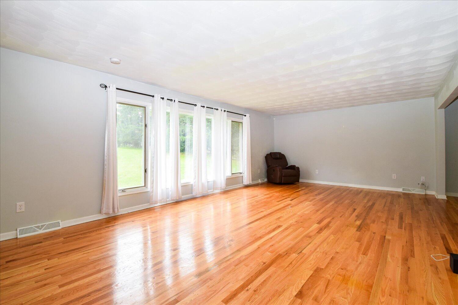 1316 Dudley Road Moneta, VA 24121 - Photo 9 of 37 a view of empty room with wooden floor and fan