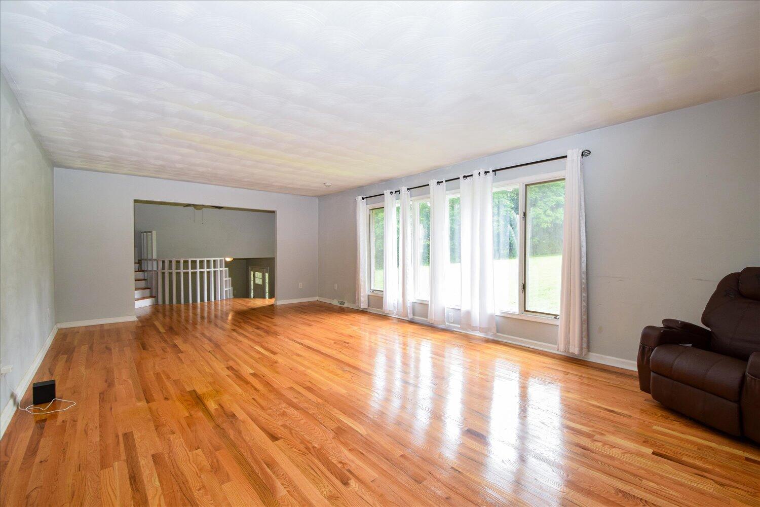 1316 Dudley Road Moneta, VA 24121 - Photo 10 of 37 a view of an empty room with wooden floor and a window