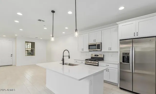 a kitchen with a refrigerator and a sink