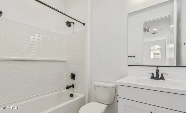 a bathroom with a sink toilet vanity and shower