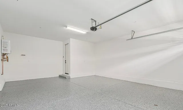 an empty room with ceiling fan and windows