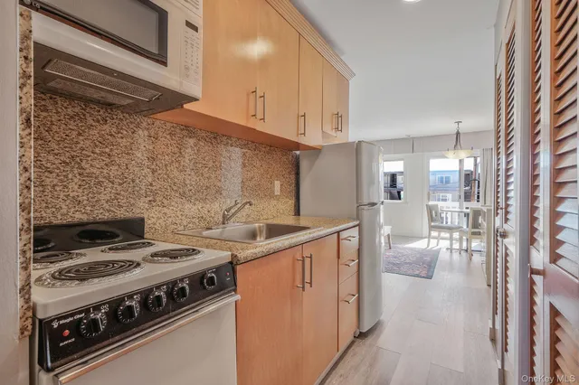 a kitchen with a stove and white cabinets