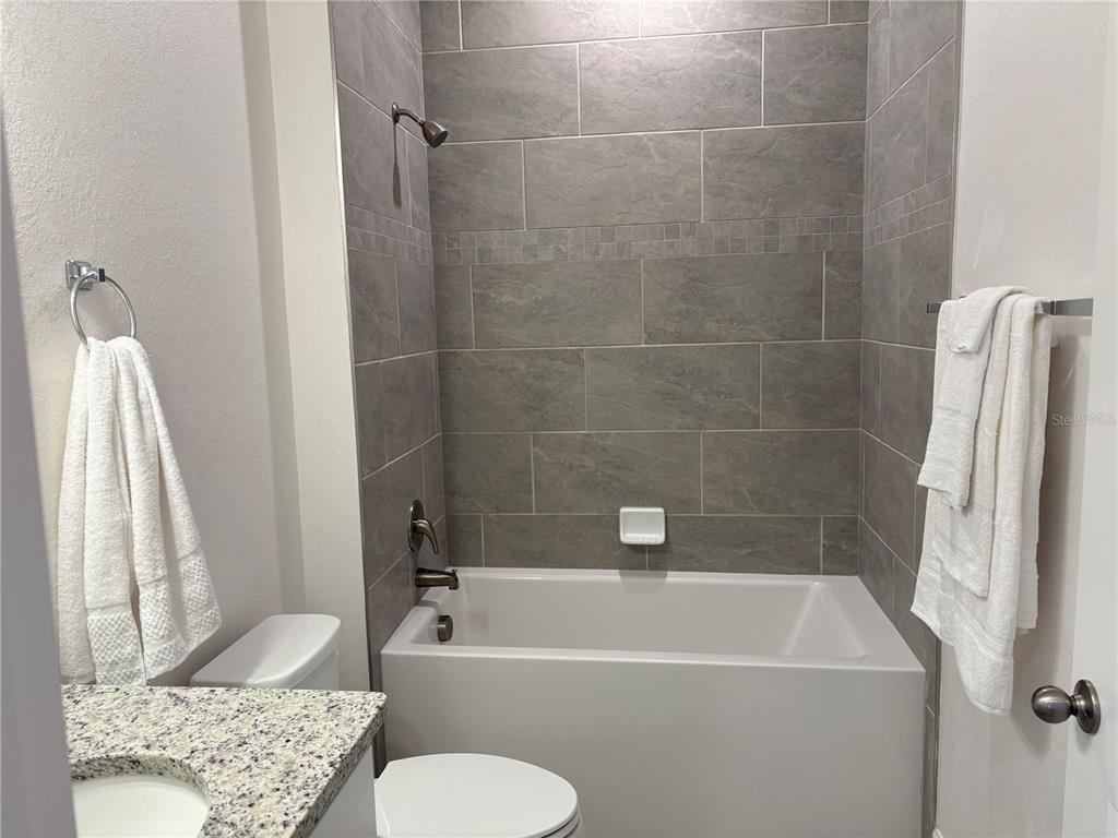 15467 Maynard Avenue Port Charlotte, FL 33953 - Photo 11 of 13 a bathroom with a sink a window and toilet