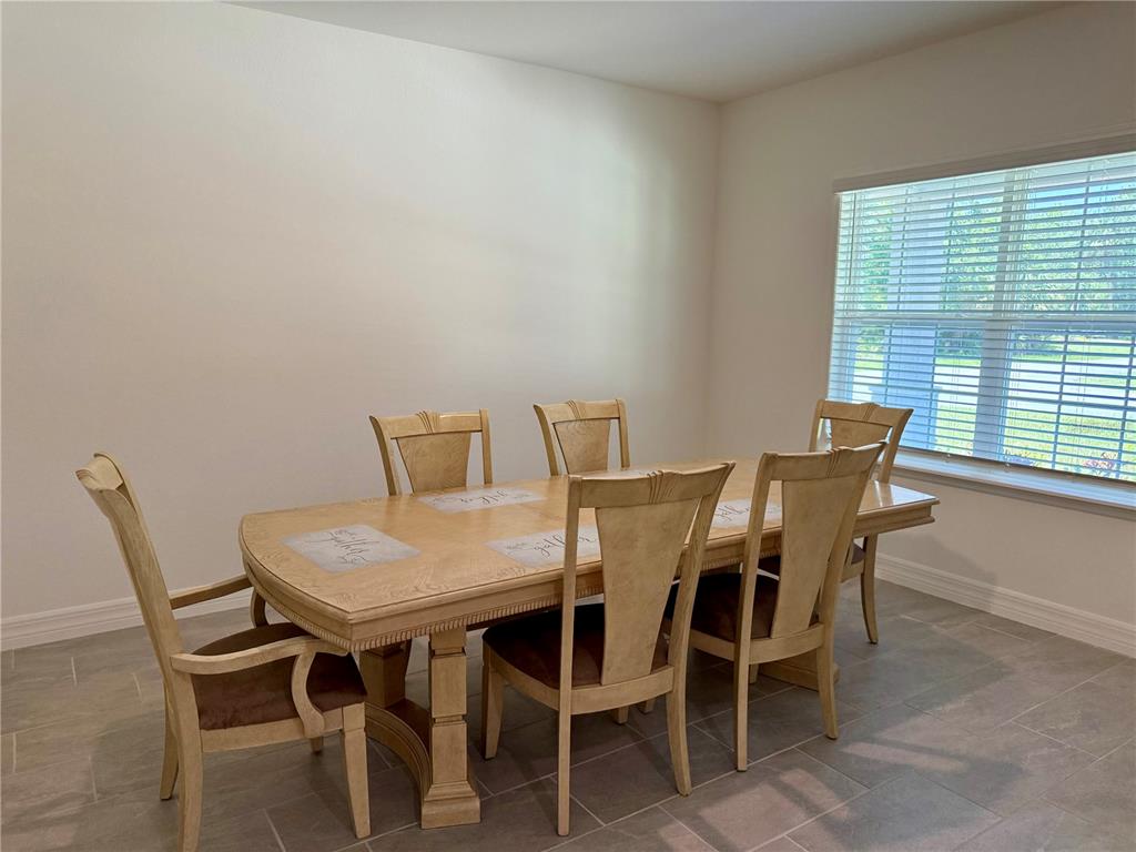 15467 Maynard Avenue Port Charlotte, FL 33953 - Photo 4 of 13 a view of a dining room with furniture and window