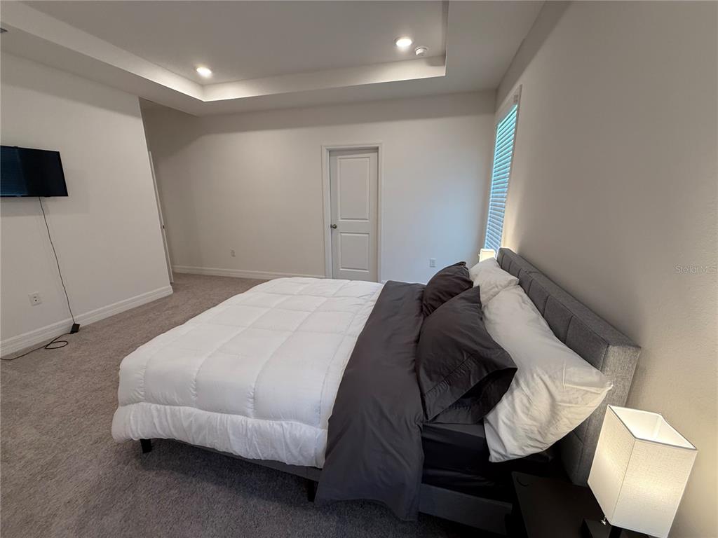 15467 Maynard Avenue Port Charlotte, FL 33953 - Photo 6 of 13 a bedroom with a bed and a television