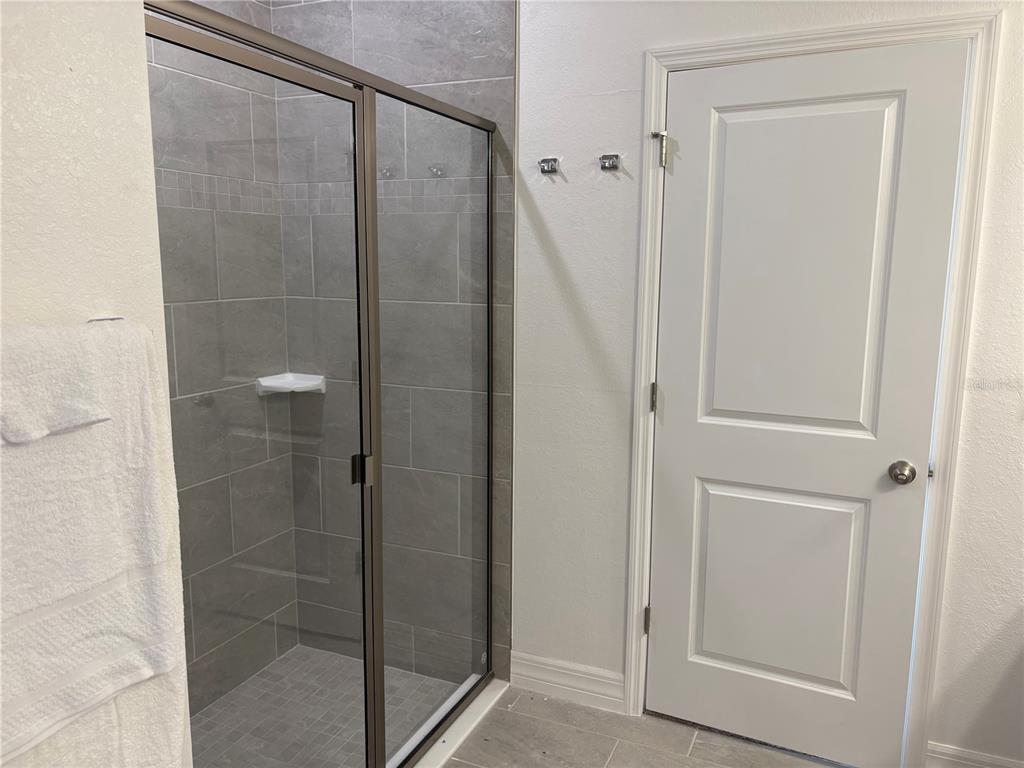 15467 Maynard Avenue Port Charlotte, FL 33953 - Photo 10 of 13 a bathroom with a glass shower door