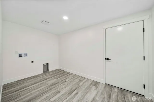 a view of a room with wooden floor