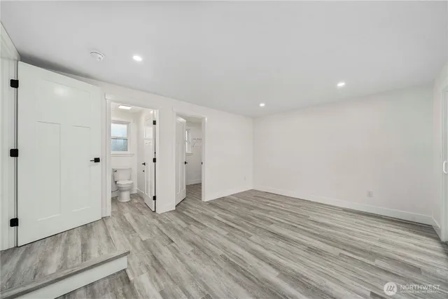 a view of empty room with wooden floor