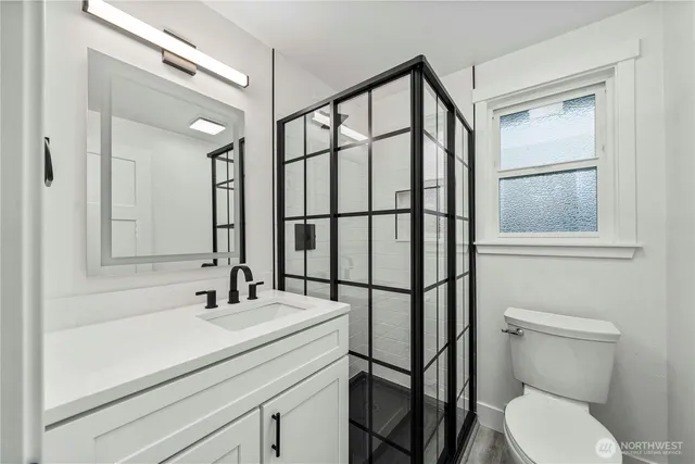 a bathroom with a toilet a sink and a mirror