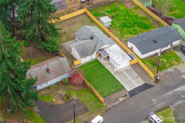 an aerial view of a house with a garden and deck