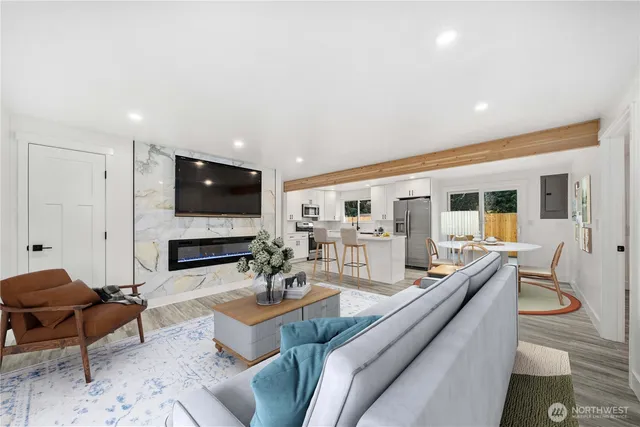 a living room with fireplace furniture and a flat screen tv