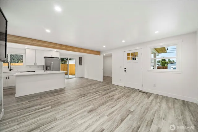 a view of kitchen with wooden floor and electronic appliances
