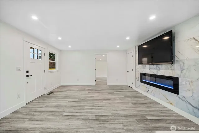 a view of empty room with a flat screen tv and fireplace