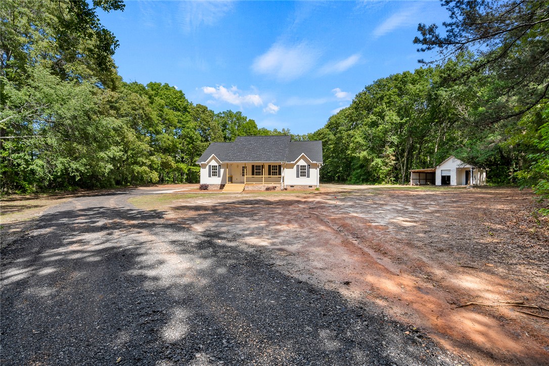 131 Lockaby Road Pelzer, SC 29669 - Photo 5 of 50 This charming home features a classic exterior and a spacious yard, offering both comfort and privacy.