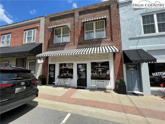 a view of a building with car parked