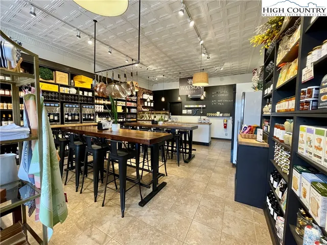 a dinning area with lots of furniture and swimming pool