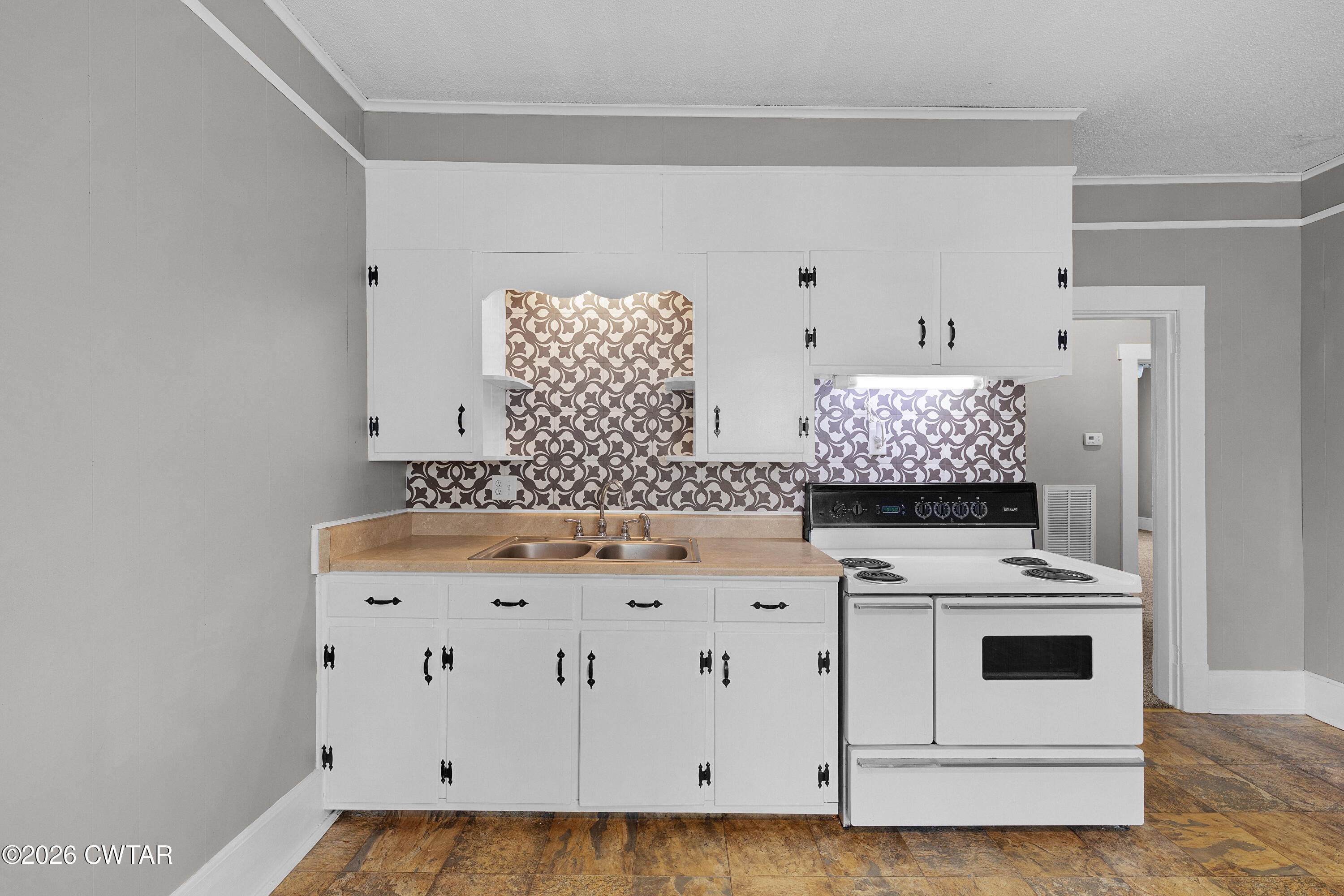 2 Gregg Street Jackson, TN 38301 - Photo 15 of 18 a kitchen with stainless steel appliances a stove a sink and white cabinets