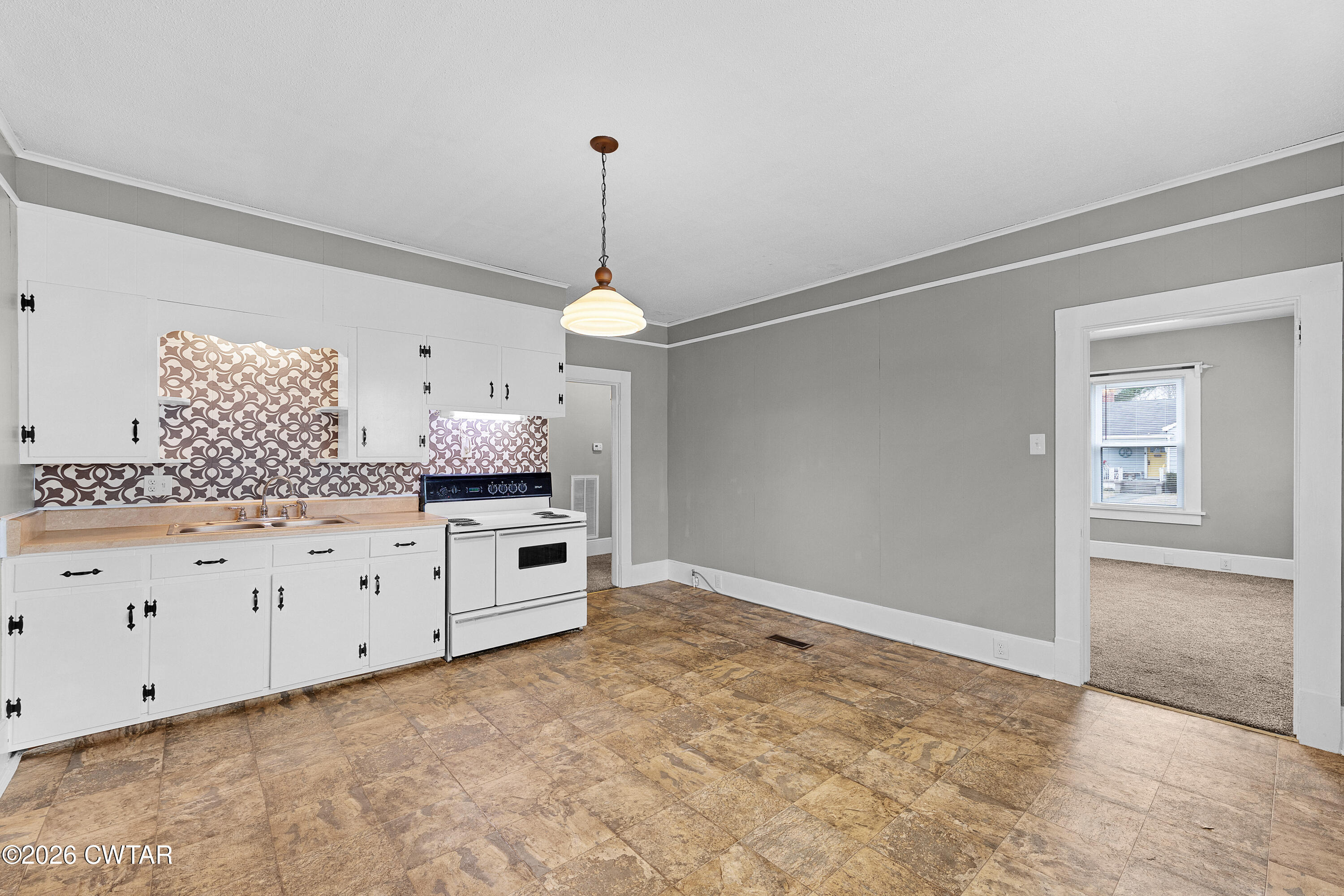 2 Gregg Street Jackson, TN 38301 - Photo 17 of 18 a kitchen with granite countertop white cabinets and white appliances