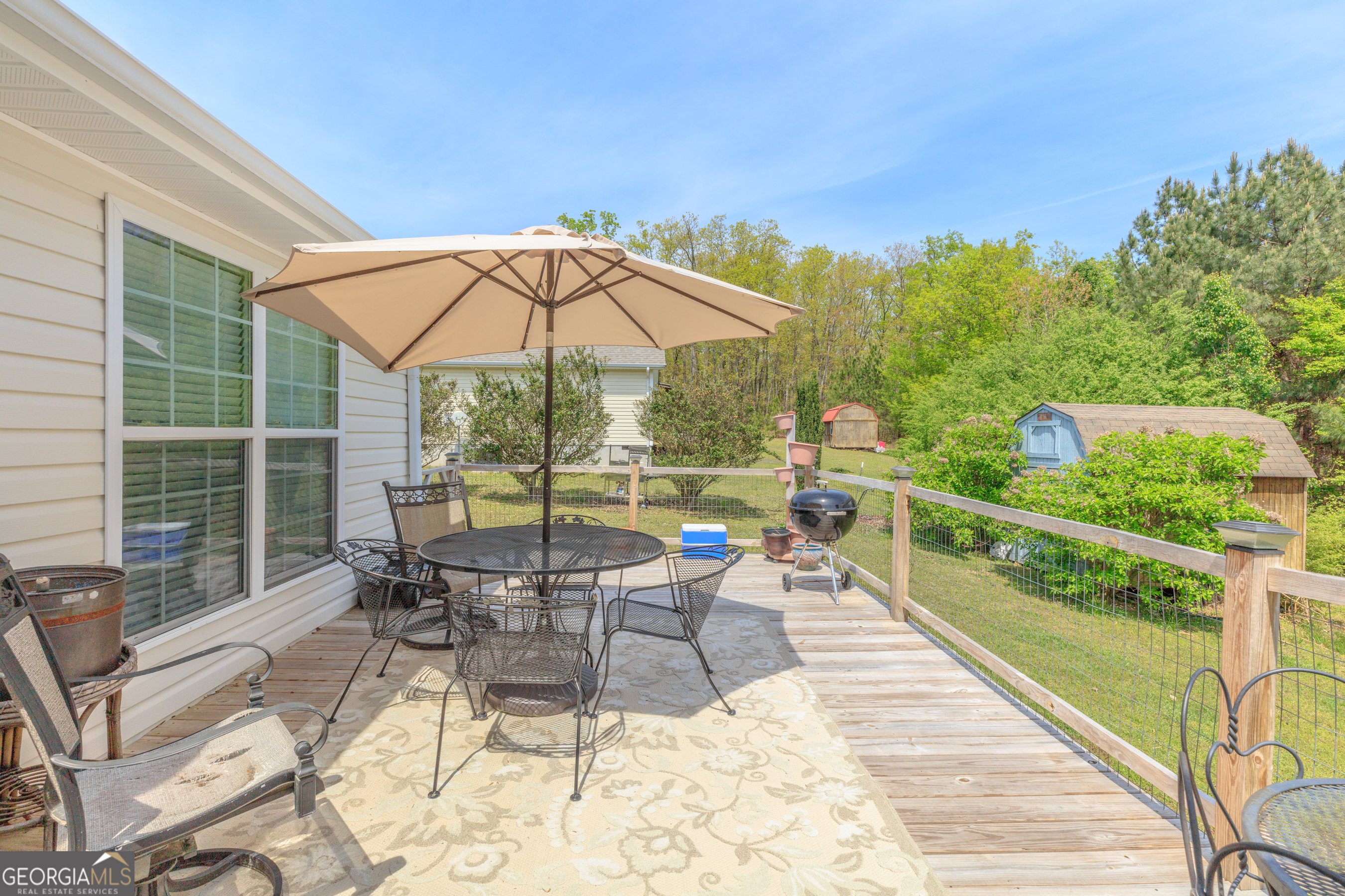 765 Greenbush Road LaFayette, GA 30728 - Photo 51 of 68 a view of a chairs and table in patio with a small yard