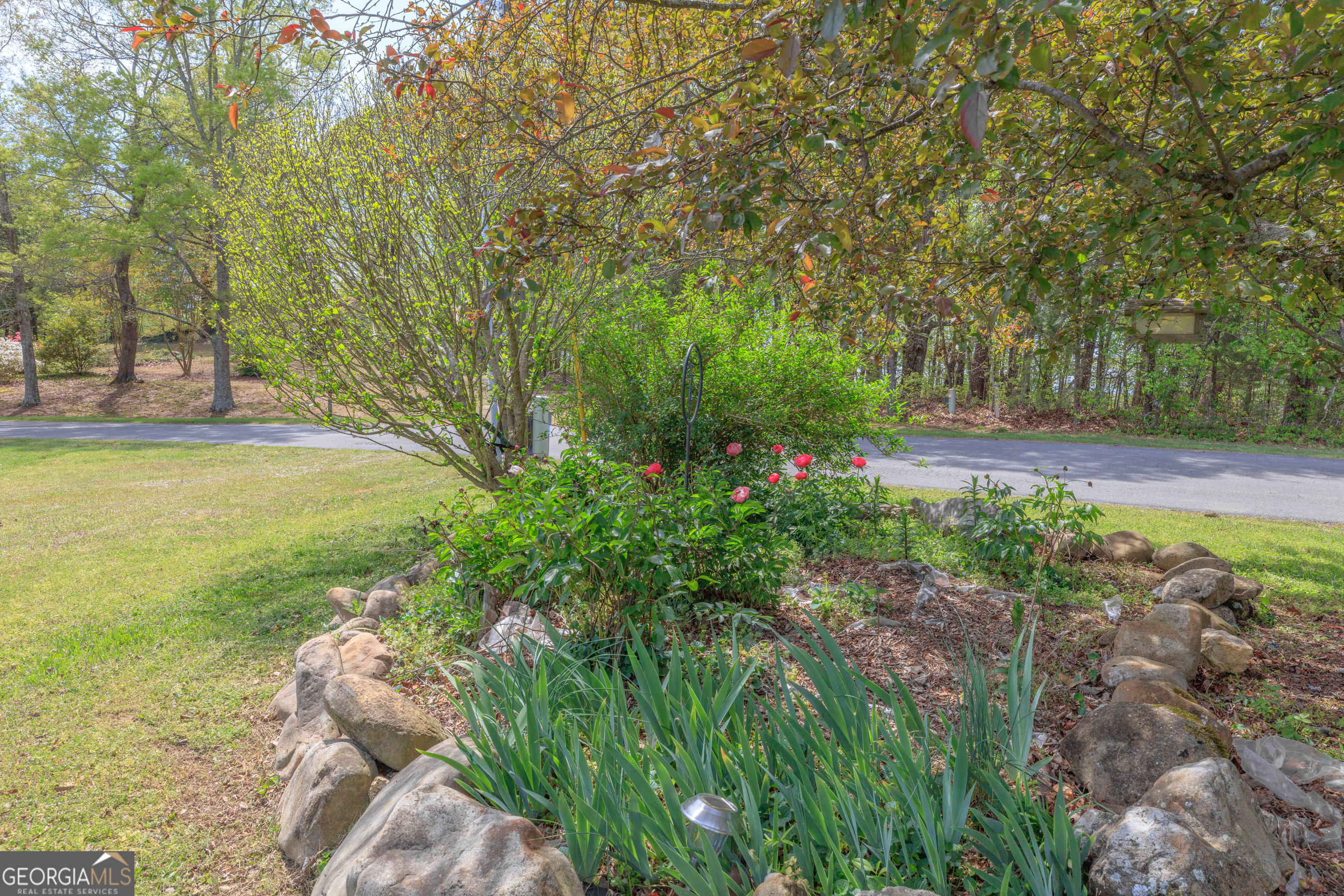 765 Greenbush Road LaFayette, GA 30728 - Photo 58 of 68 a view of a garden with lawn chairs under an umbrella
