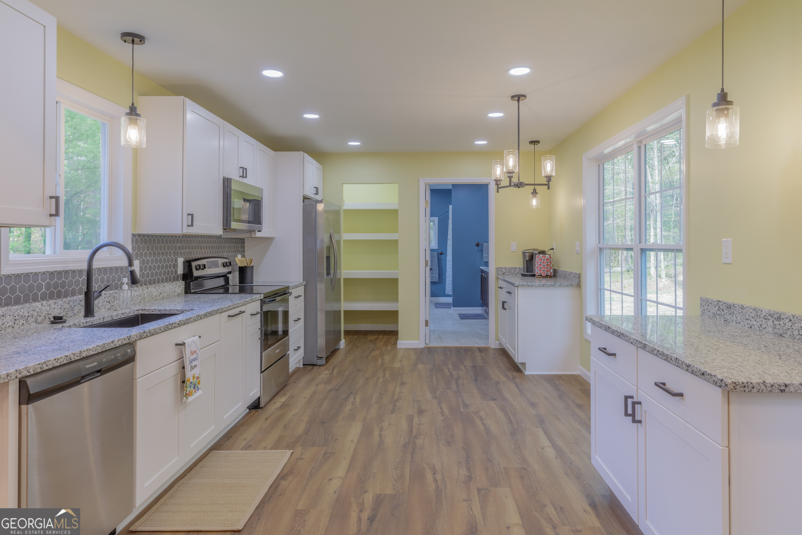 765 Greenbush Road LaFayette, GA 30728 - Photo 7 of 68 a large kitchen with stainless steel appliances a large counter top a sink a refrigerator and a window