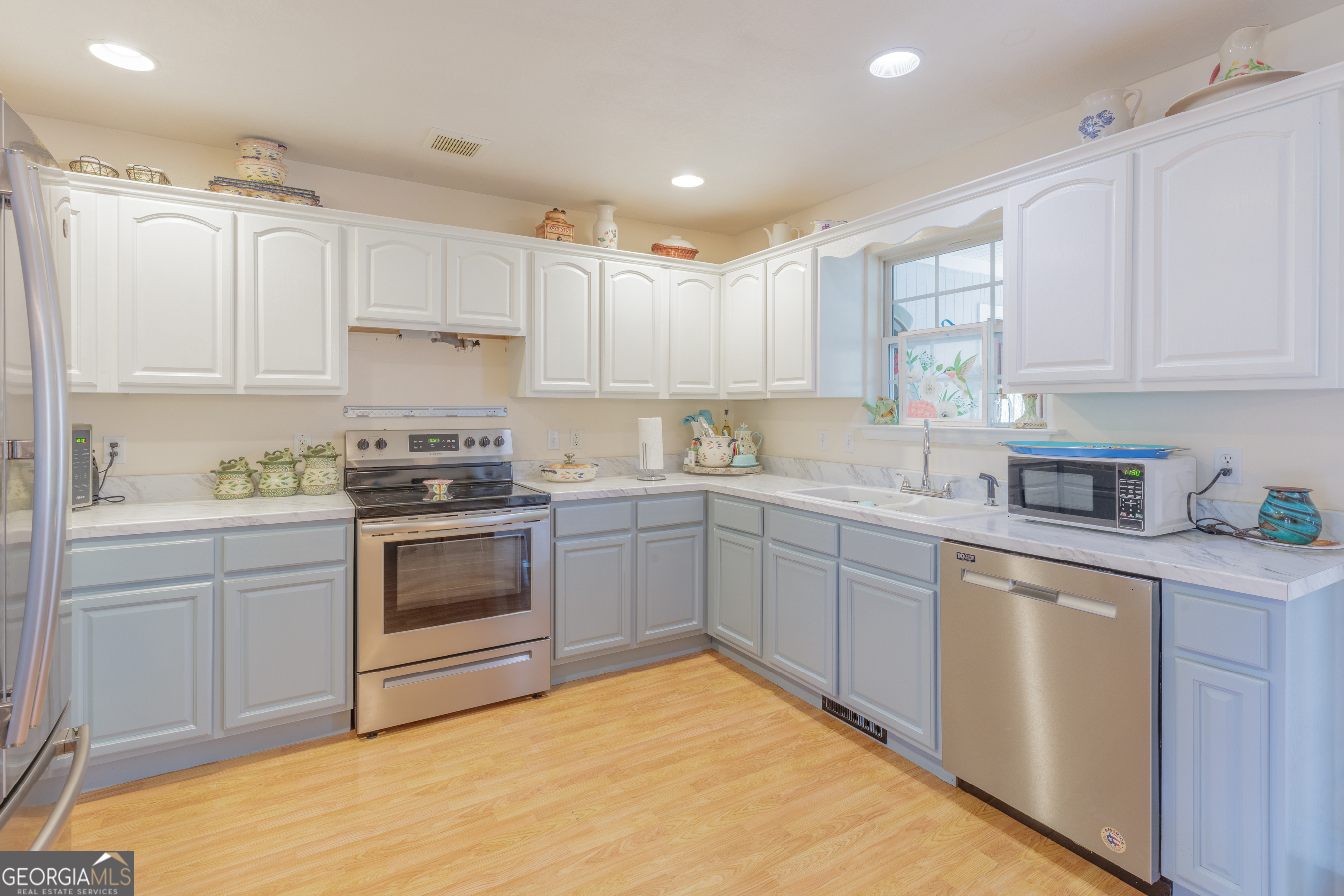 765 Greenbush Road LaFayette, GA 30728 - Photo 8 of 68 a kitchen with a white cabinets and white appliances