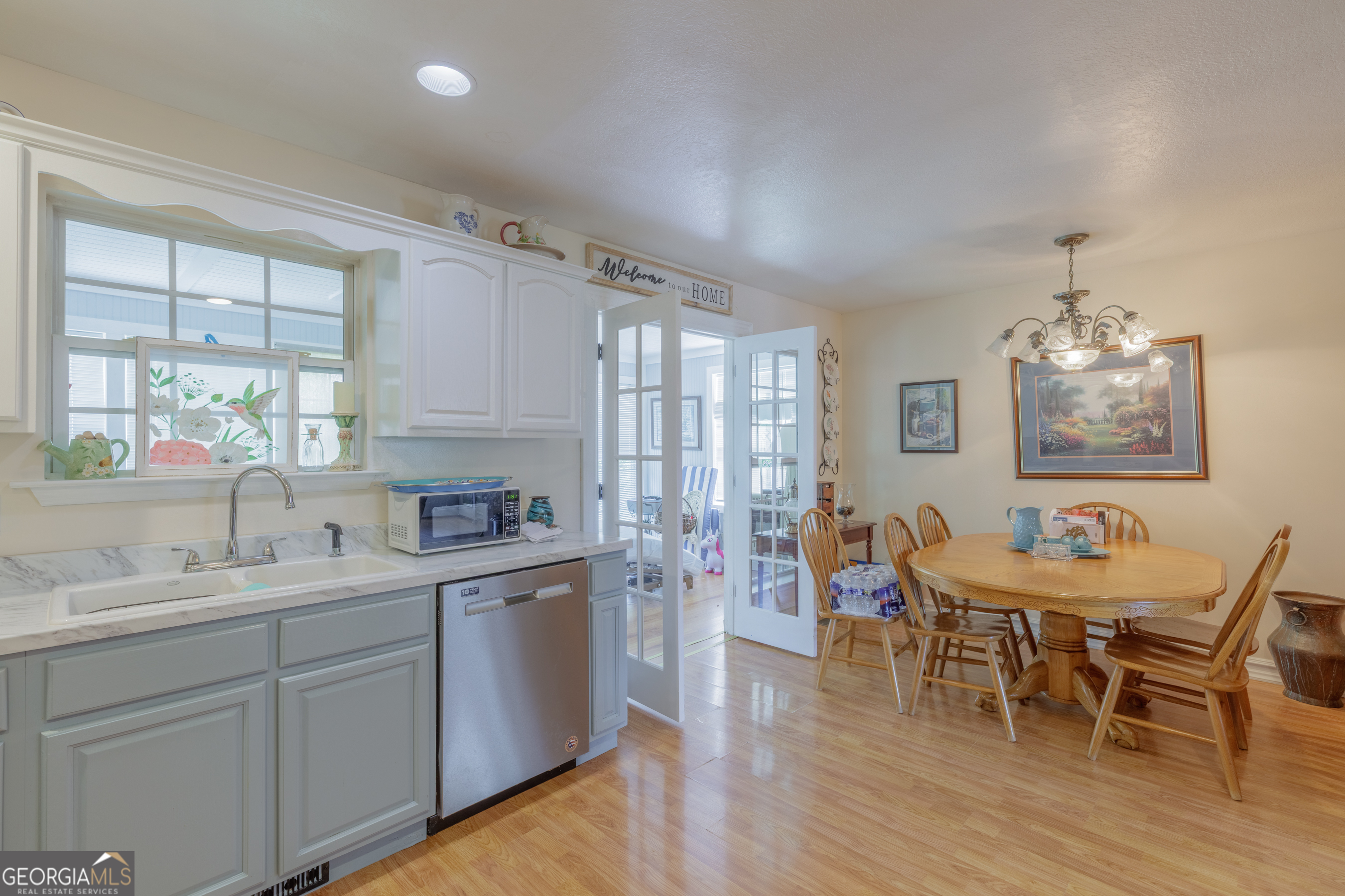 765 Greenbush Road LaFayette, GA 30728 - Photo 10 of 68 a kitchen with stainless steel appliances granite countertop a table chairs stove and sink