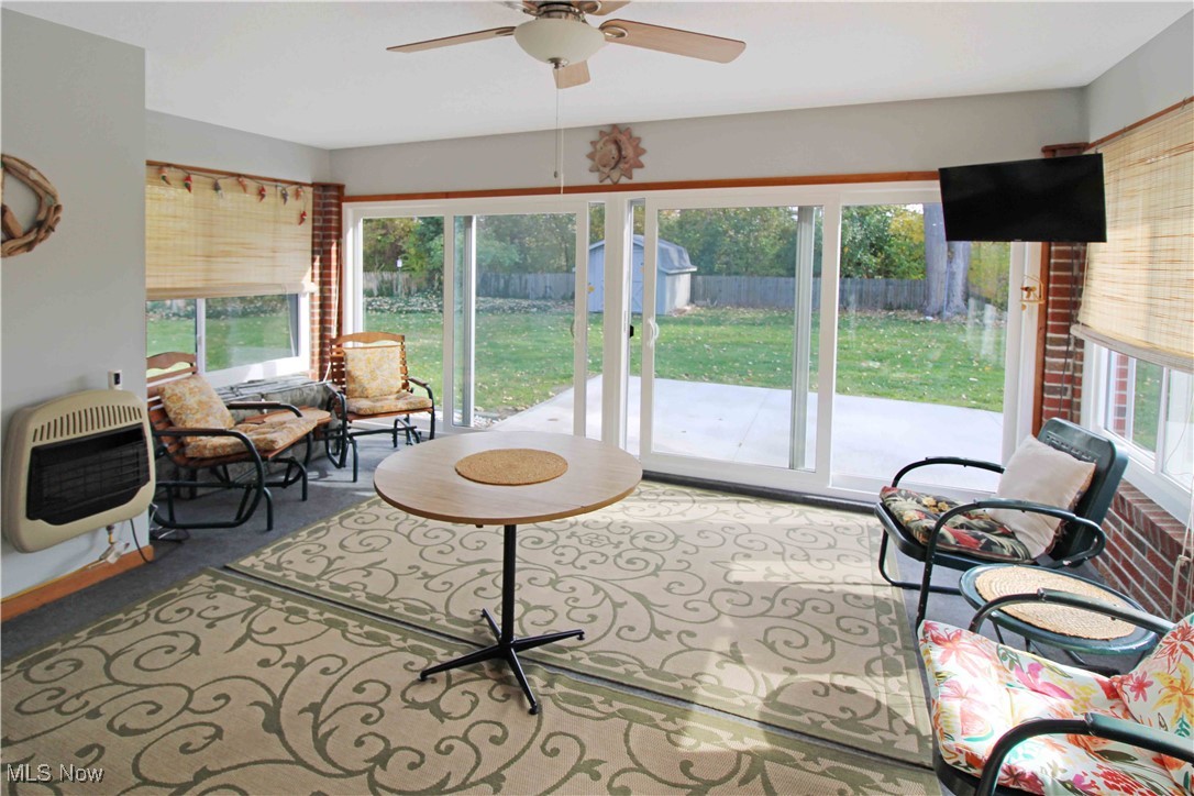 2708 East Sand Road Port Clinton, OH 43452 - Photo 18 of 33 Carpeted living room with heating unit and ceiling fan
