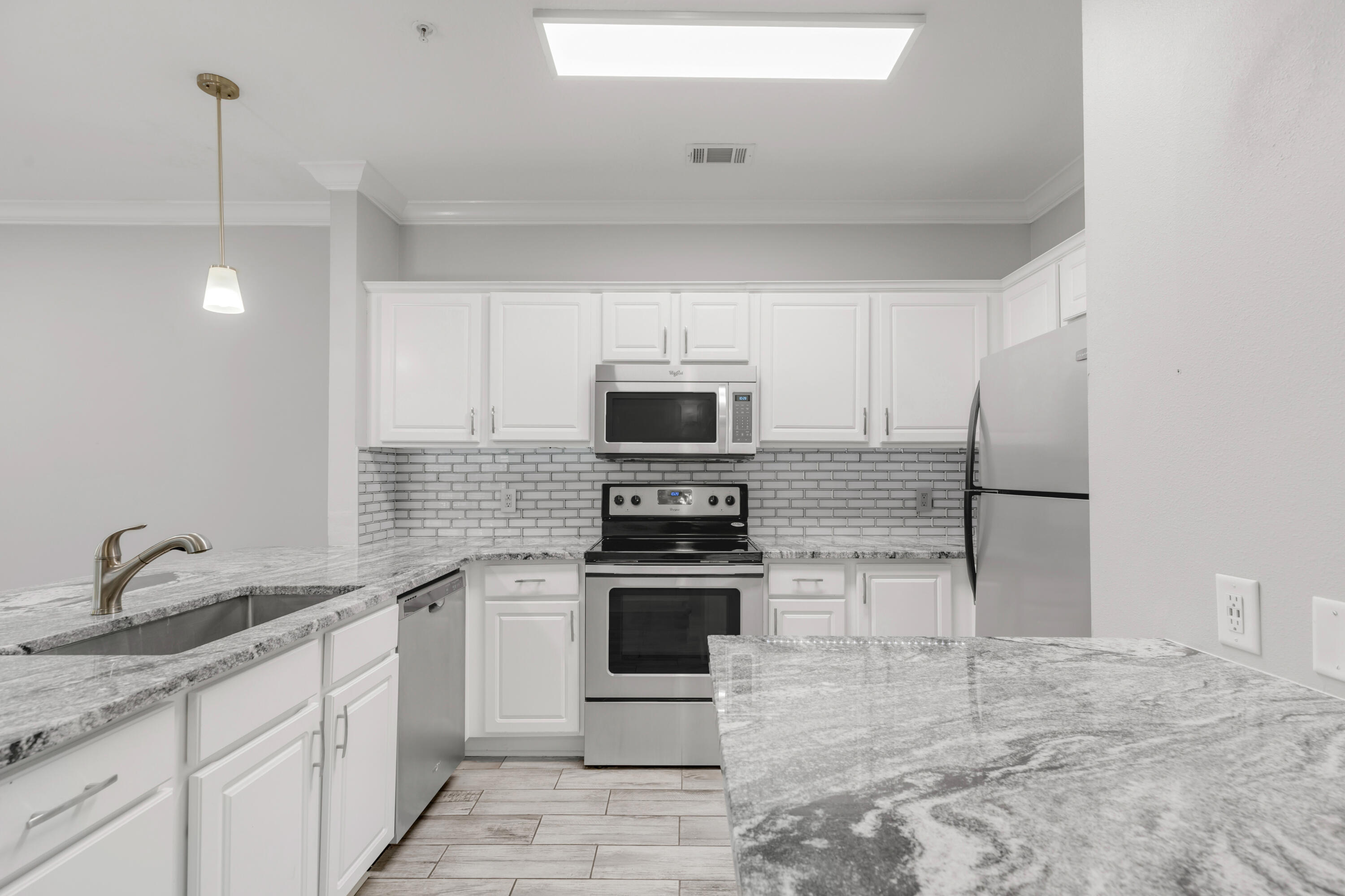 a kitchen with stainless steel appliances granite countertop a stove and a sink