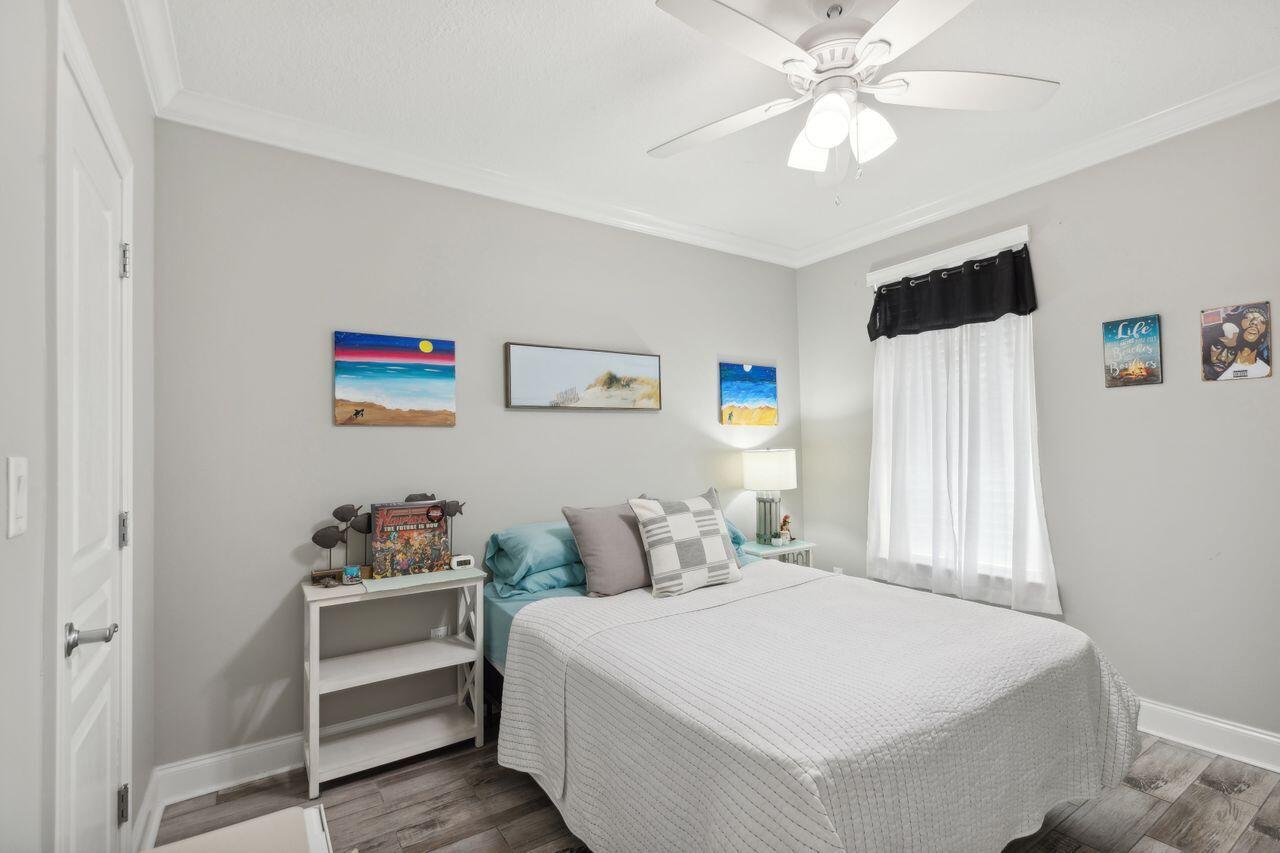 159 Brooks Street Southeast, Unit 207 Fort Walton Beach, FL 32548 - Photo 14 of 30 a bedroom with a bed and a chandelier