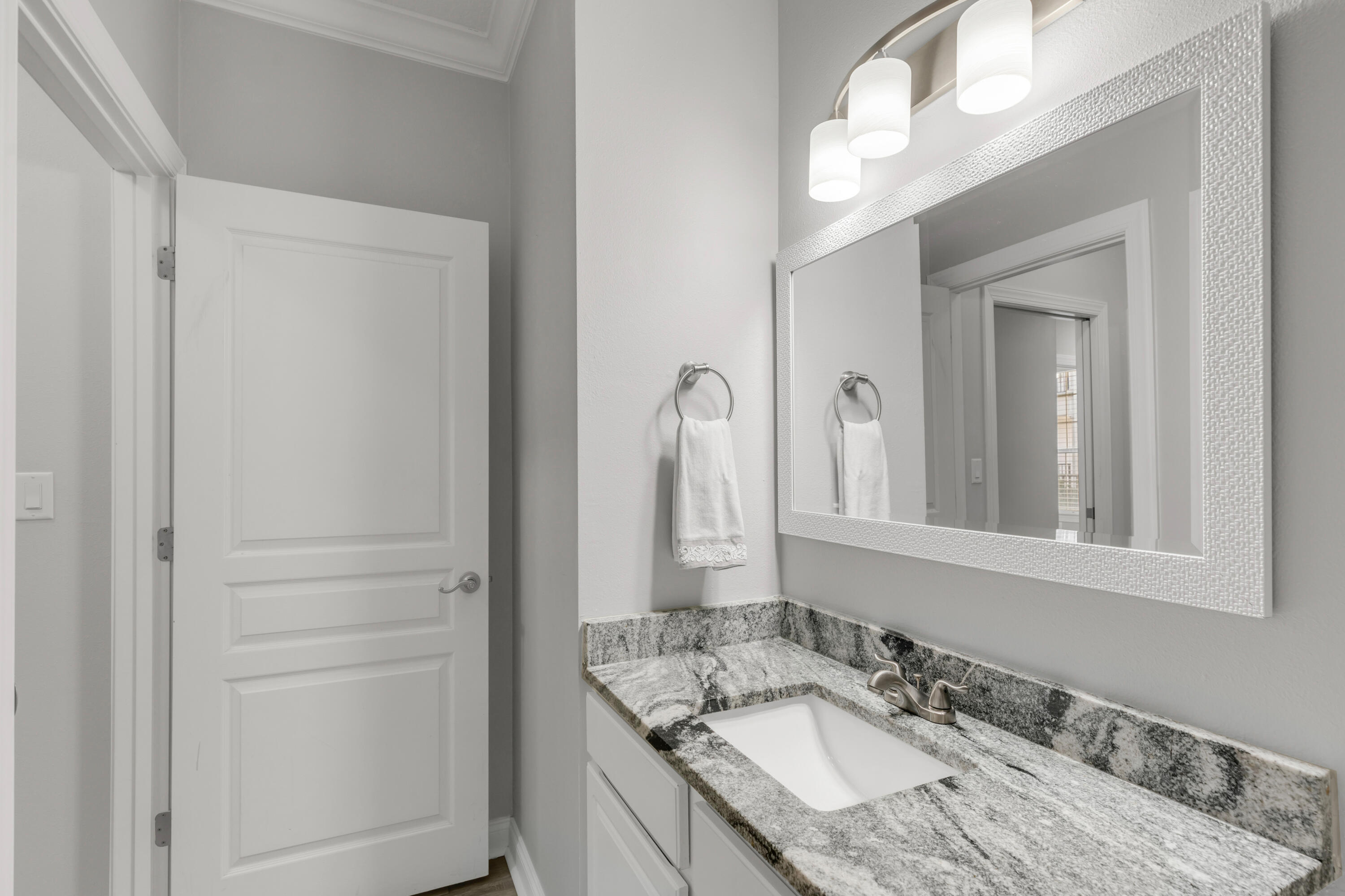 159 Brooks Street Southeast, Unit 207 Fort Walton Beach, FL 32548 - Photo 16 of 30 a bathroom with a granite countertop sink and a mirror