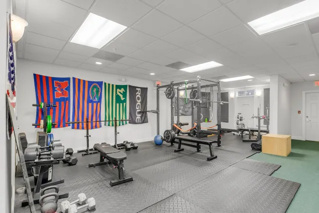 a living room with furniture and floor to ceiling window