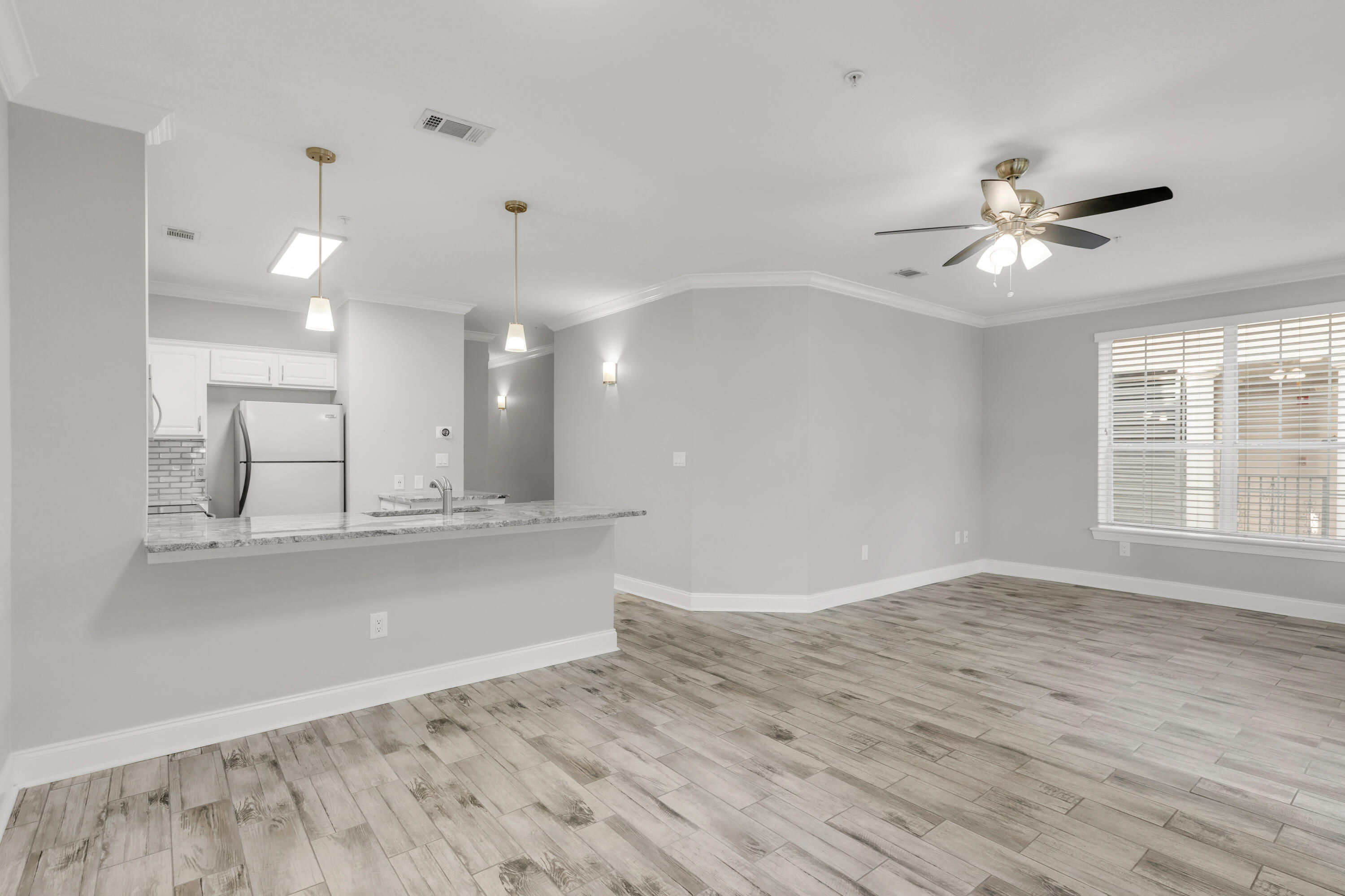 159 Brooks Street Southeast, Unit 207 Fort Walton Beach, FL 32548 - Photo 4 of 30 a view of a kitchen with wooden floor and a ceiling fan