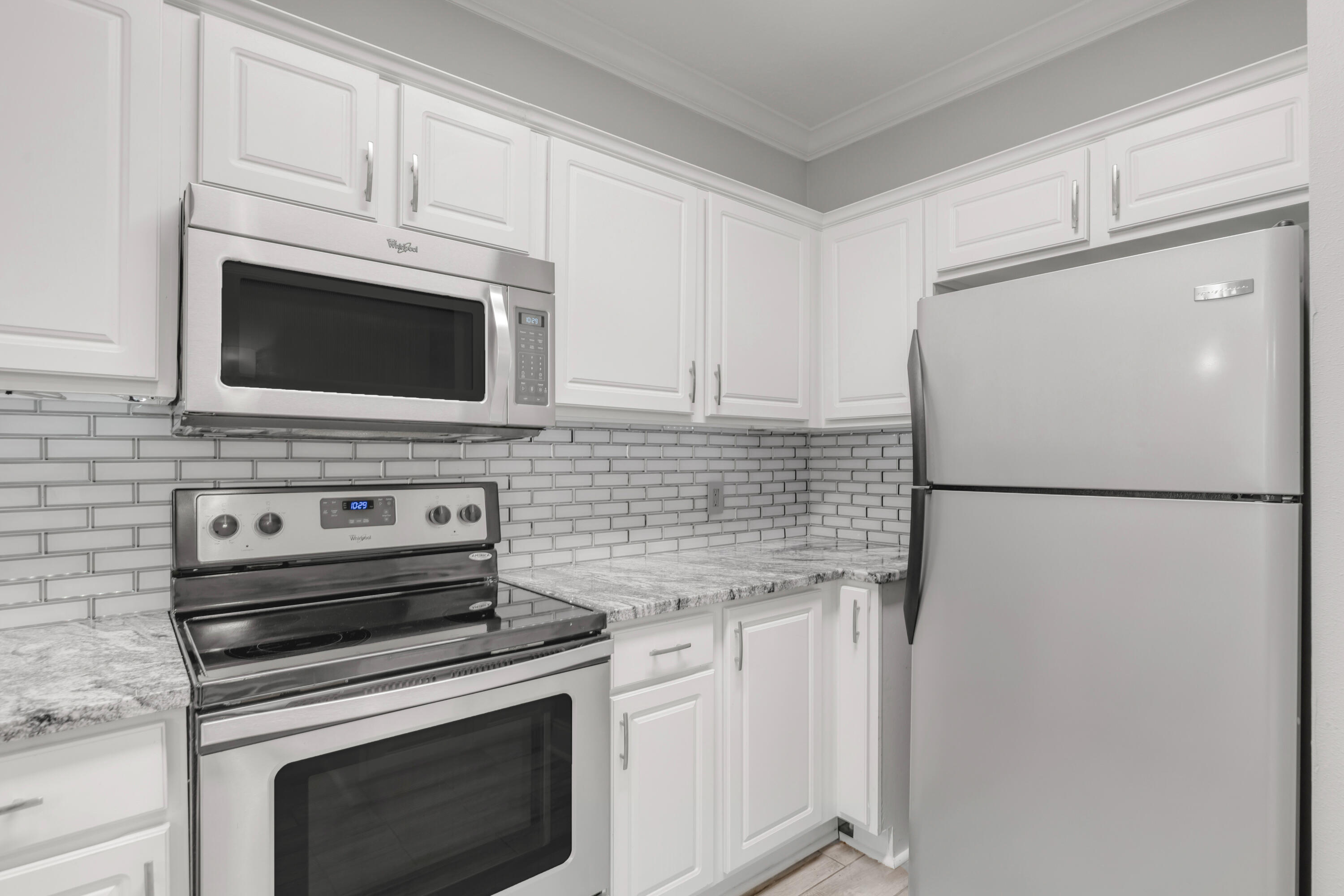 159 Brooks Street Southeast, Unit 207 Fort Walton Beach, FL 32548 - Photo 7 of 30 a kitchen with cabinets stainless steel appliances and a counter space