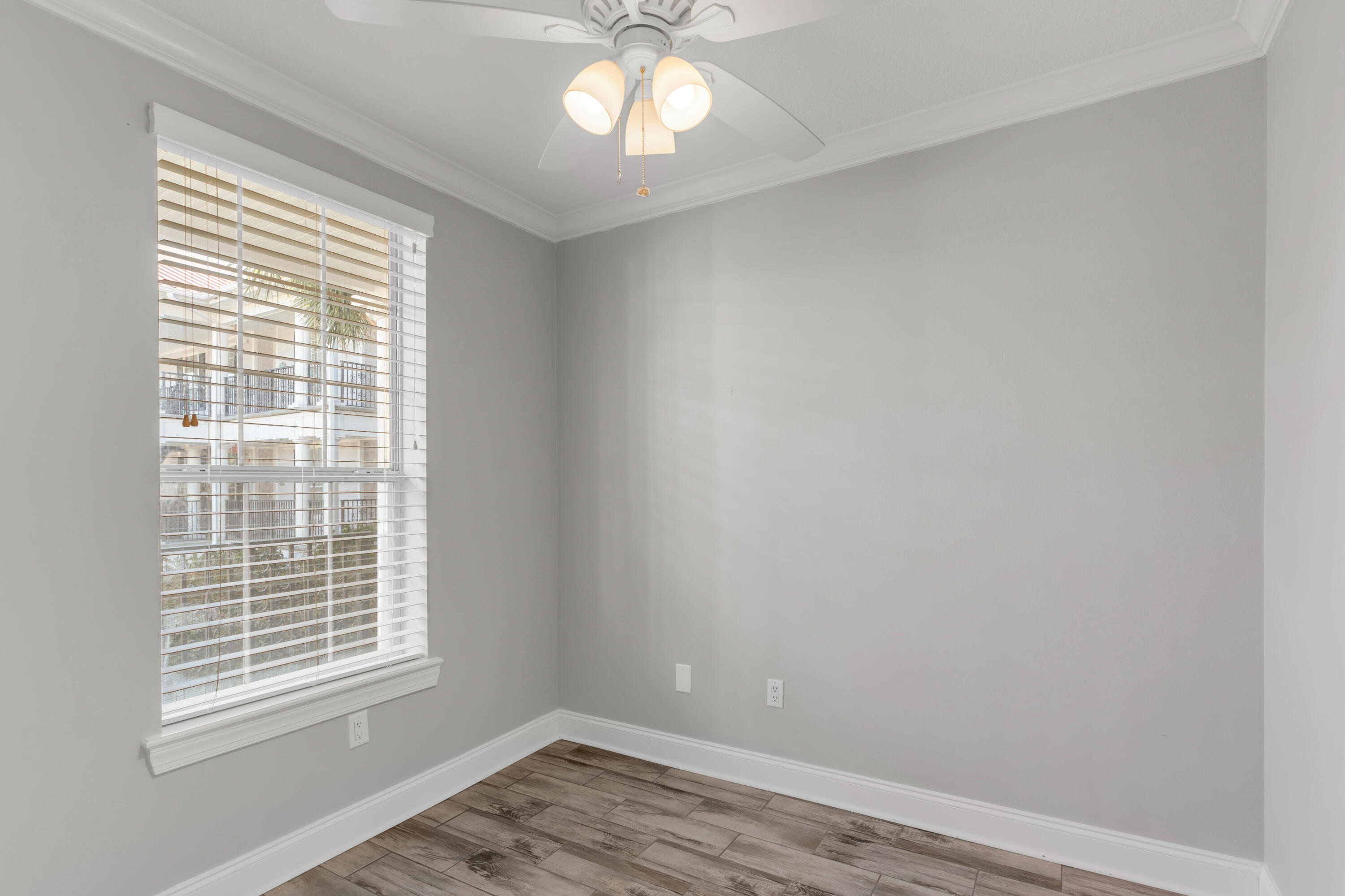 159 Brooks Street Southeast, Unit 207 Fort Walton Beach, FL 32548 - Photo 10 of 30 a view of an empty room with wooden floor and a window