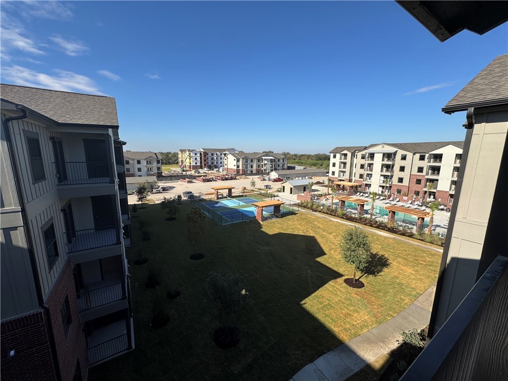 6000 Jones Road, Unit 4211 Bryan, TX 77807 - Photo 18 of 19 a view of balcony with floor to ceiling windows and wooden floor