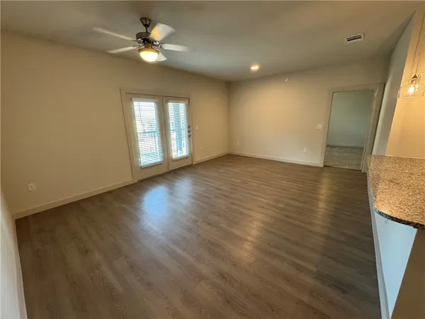 an empty room with closet and fan