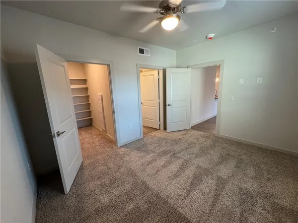 a view of a livingroom with a ceiling fan and window