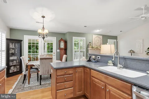 a kitchen with granite countertop a sink cabinets and wooden floor