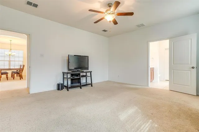 a view of a livingroom with a flat screen tv and a ceiling fan