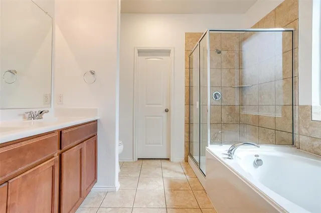 a bathroom with a tub shower and sink