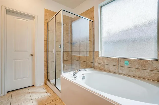 a bathroom with a bathtub and shower